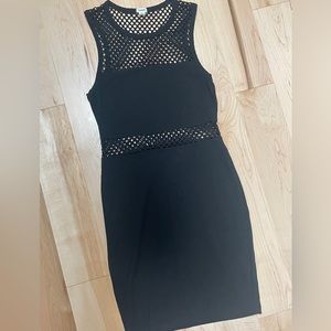 Black fitted dress with cutouts for an attractive style & fit. Garage, size XS